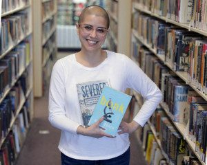 charnee6716landscapeweb Staff member holding books